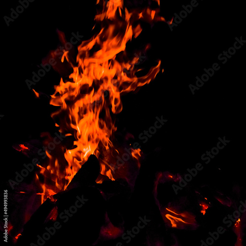 Fire flames on black background, Blaze fire flame texture background, Beautifully, the fire is burning, Fire flames with wood & cow dung © rahul
