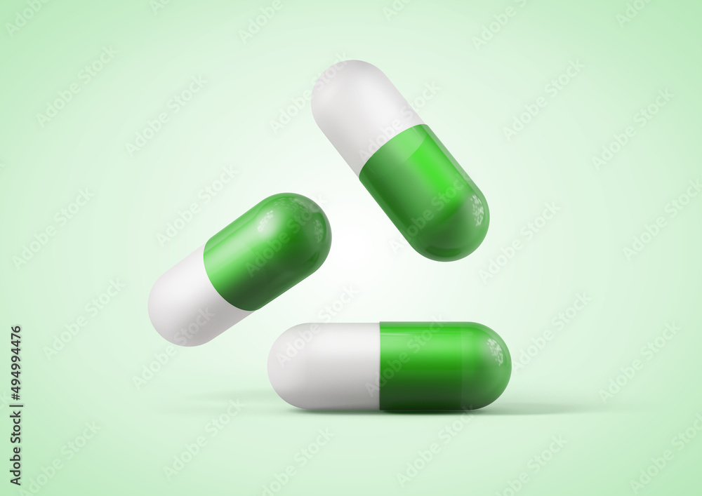 Green medication capsules isolated from the background Green medication capsules isolated from the background