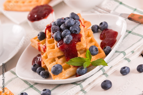 Waffles with blueberries and jam. 