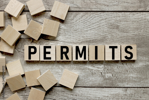 permits text on wooden cubes on wooden background photo