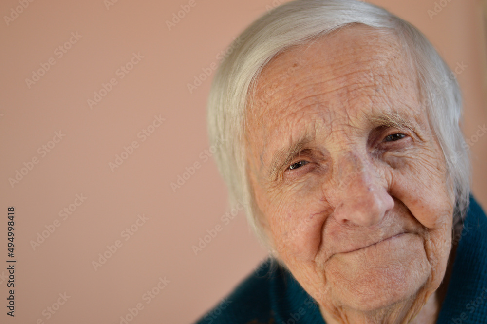 Portrait of a smiling senior 90 years woman. Studio shot over beige background. Portrait of a smiling senior 90 years woman. Studio shot over beige background.