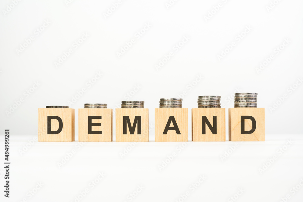demand - text written on wooden block with stacked coins on white background, growing trend demand - text written on wooden block with stacked coins on white background, growing trend