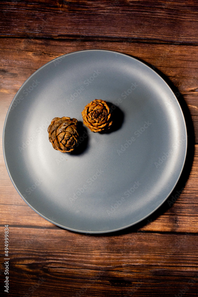 a lot of fir cones on a round plate a lot of fir cones on a round plate