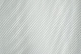 Close-up of white mesh polyester fabric. White sports jersey shirts background.