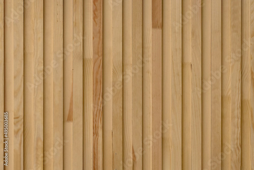 Seamless pattern of modern wall covering with vertical wooden slats for background photo