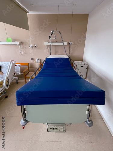 Vertical photograph of an empty hospital bed