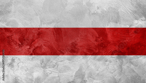 Textured photo of the flag of Belarus, red with white colors.
