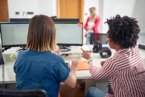 Female coworkers consulting together in the office