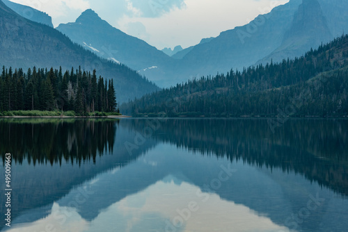 Layers of Two Medicine Reflects In The Still Lake Below photo