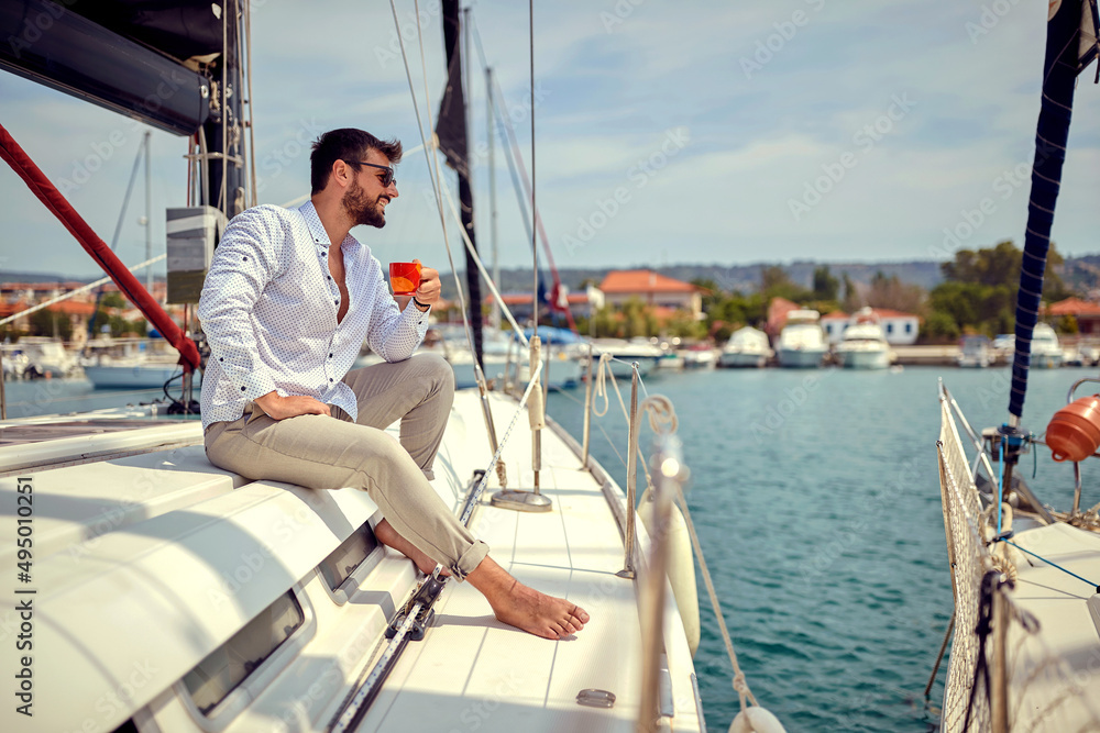 Casual handsome man sailing alone Casual handsome man sailing alone
