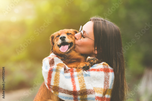 Photos Beautiful woman hugging and kissing dog