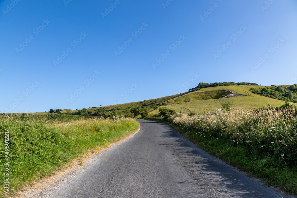The Road to Firle Beacon in the South Downs, with a blue sky overhead