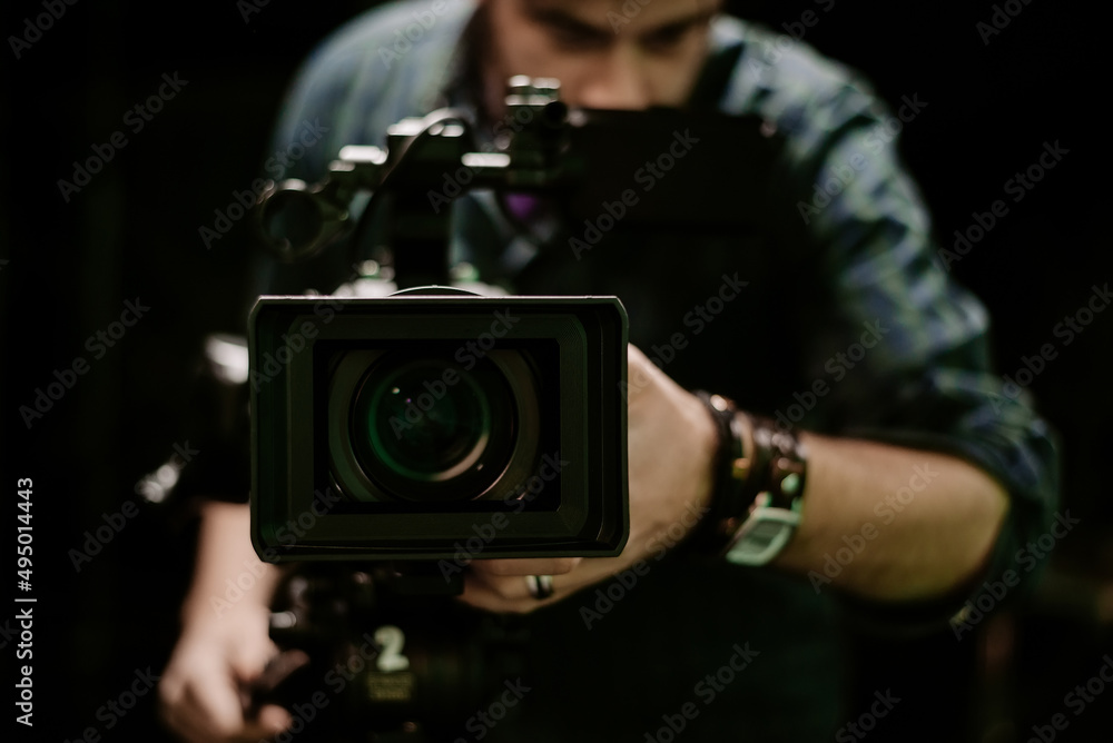 studio camera with man in the background recording