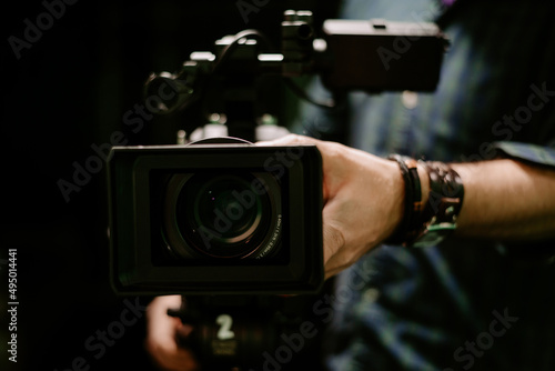 camera lens recording with man hand in studio close up