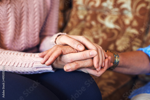 We in this together  you are not alone. Cropped shot of unrecognizable women holding hands at home.