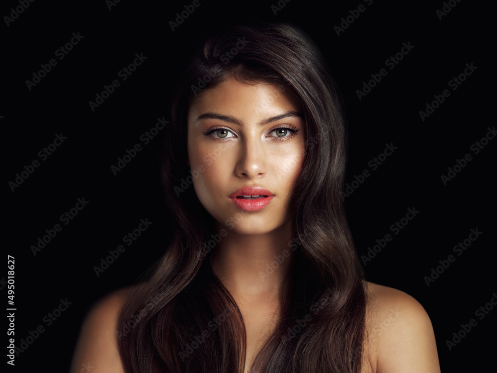 Her beauty dazzles even in the dark. Studio shot of a beautiful woman posing against a black background. Her beauty dazzles even in the dark. Studio shot of a beautiful woman posing against a black background.