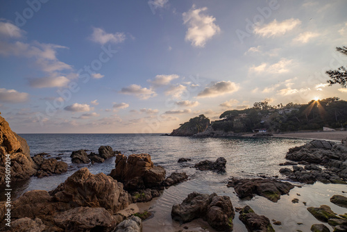 Evening sea landscape. Stones in the sea in the foreground. © Sergei