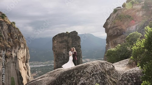 A couple in love on the rocks playing with each other