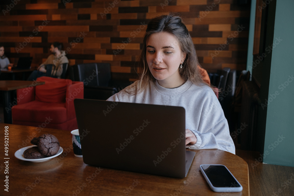freelance woman happy working in a cafe remotely freelance woman happy working in a cafe remotely