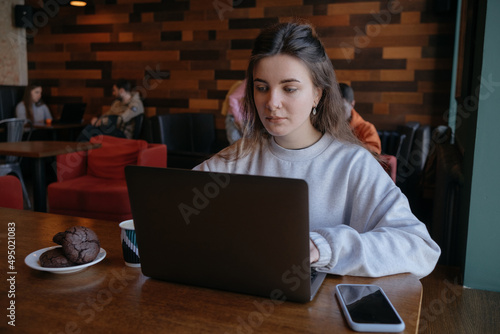 freelance woman happy working in a cafe remotely