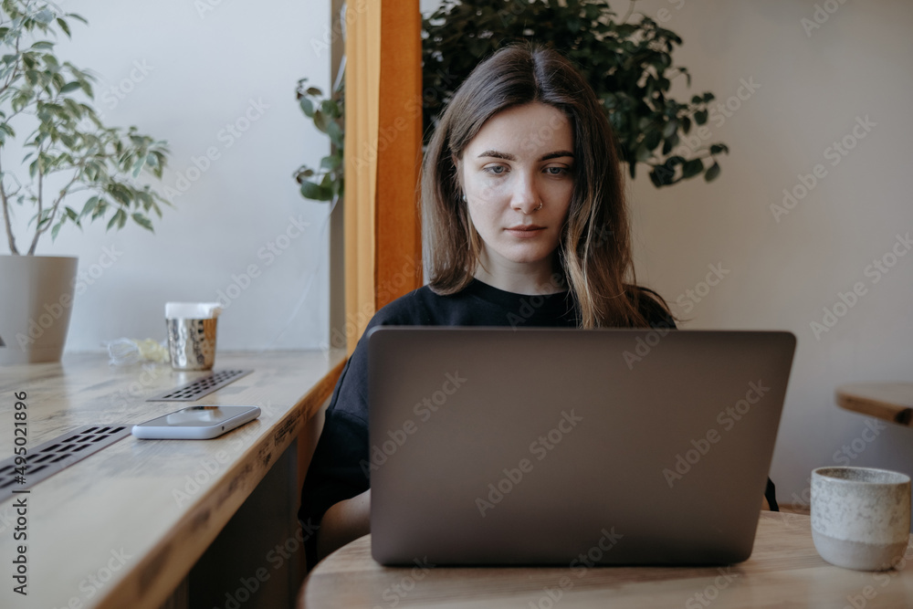 freelance woman happy working in a cafe remotely