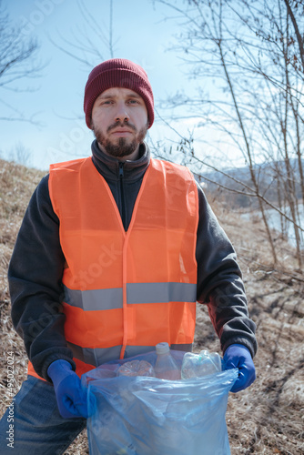 Cleaning trash in the forest, ecoactivist photo