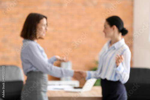 Wallpaper Mural Businesswomen shaking hands during meeting in office, blurred view Torontodigital.ca