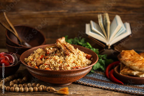 Bowl with tasty Asian pilaf on table