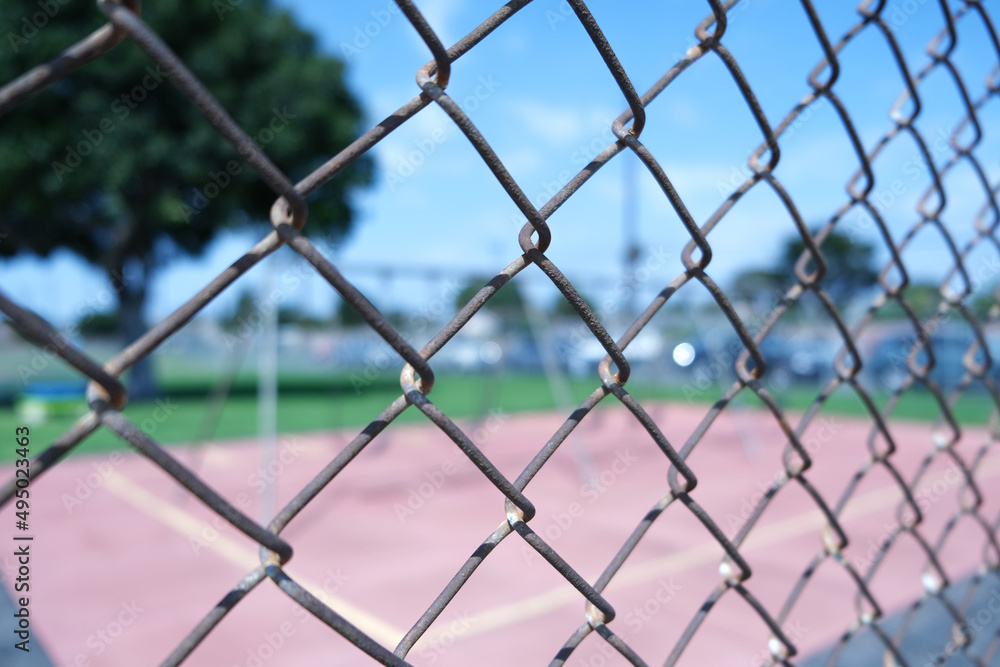 Fototapeta premium Wire fence looking into a school playground