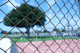 Wire fence looking into a school playground