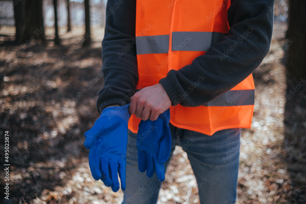 volunteer cleaner is cleaning up park and standing by bunch of garbage volunteer cleaner is cleaning up park and standing by bunch of garbage