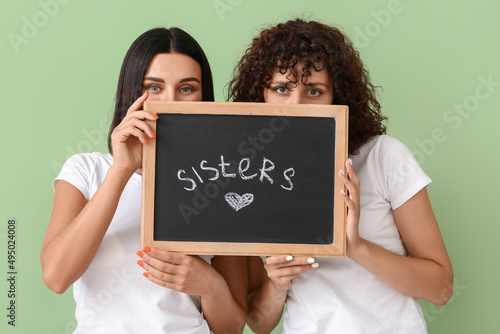 Young women holding board w...