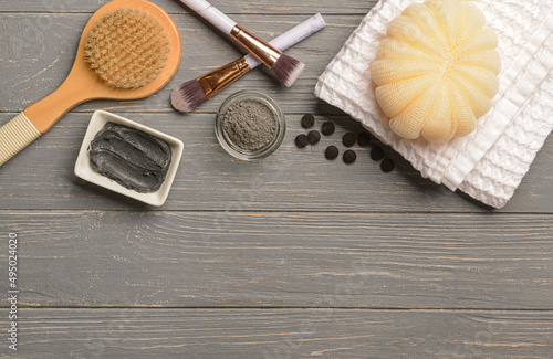Photos Bowls of activated carbon facial mask, powder, bath supplies and makeup brushes