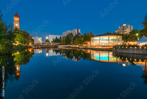 Evening view over the Spokane River of the Great Northern Clock Tower and Carousel at Riverfront Park in downtown Spokane, Washington.