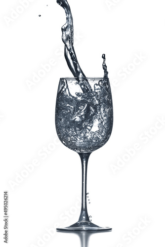 Glass of clean water with splash on white background