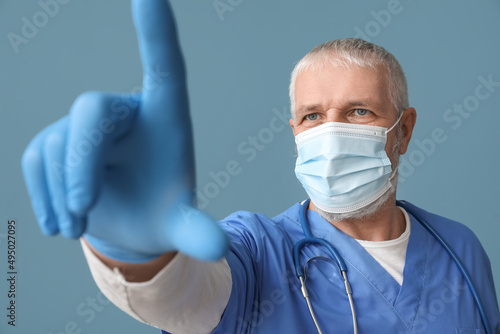 Mature male doctor in medic...