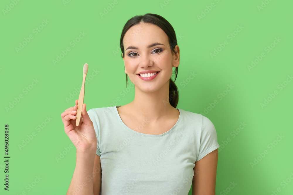 Smiling young woman with toothbrush on green background Smiling young woman with toothbrush on green background