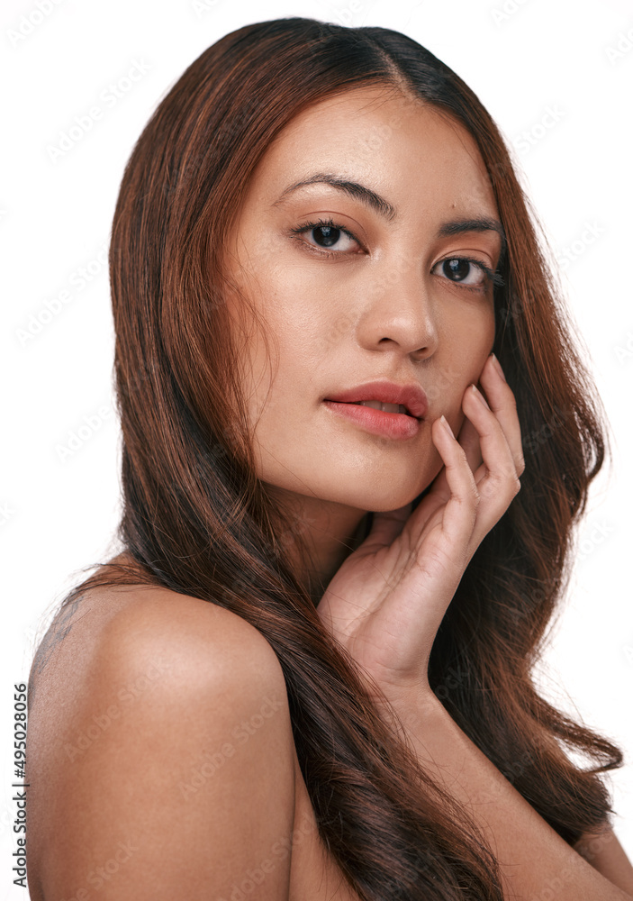 Fototapeta premium Let your skin do the talking. Studio shot of a beautiful young woman with long brown hair against a white background.