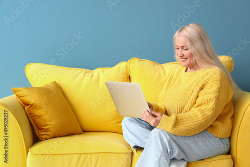 Smiling mature woman using ...