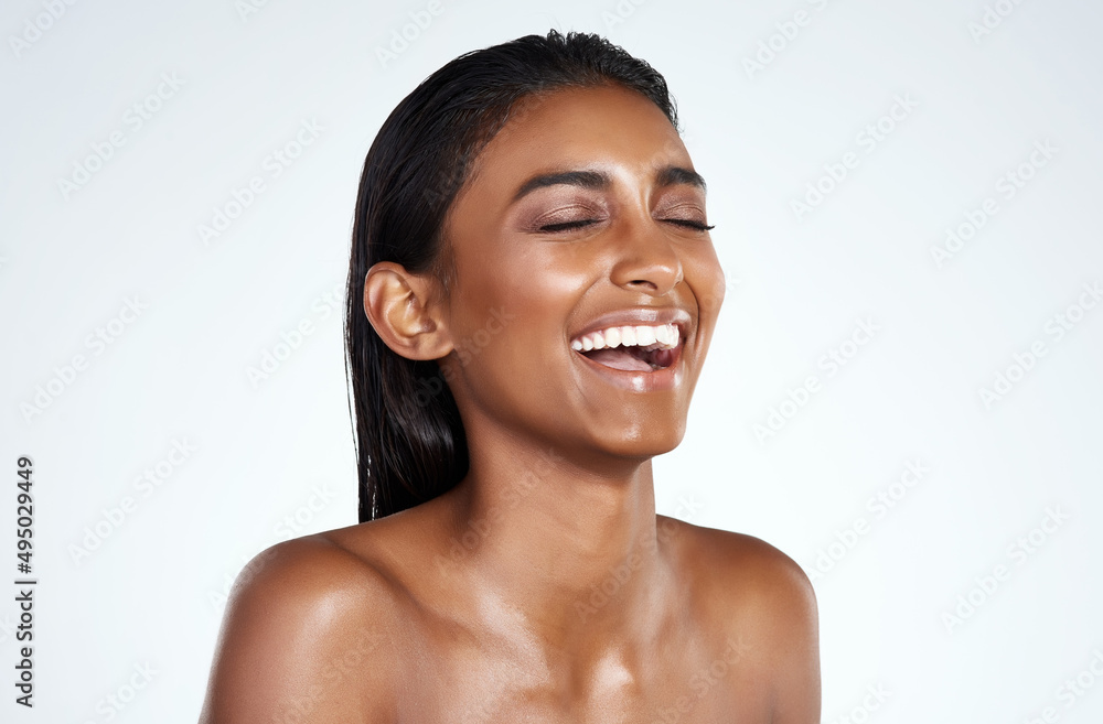 Laughter is the best facial exercise. Studio shot of a beautiful young woman posing against a light background. Laughter is the best facial exercise. Studio shot of a beautiful young woman posing against a light background.