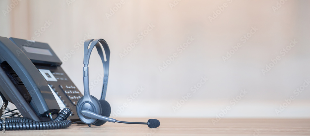 Communication support, call center and customer service help desk. VOIP headset on telephone keyboard. Communication support, call center and customer service help desk. VOIP headset on telephone keyboard.