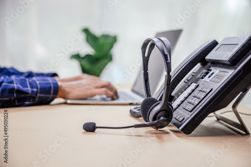 Communication support, call center and customer service help desk. telephone devices with VOIP headset in office.Customer service support (call center) concept. photo