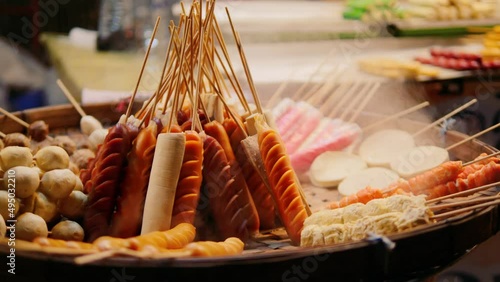 Asian Street Food: Variety of Kebabs, Satay and Sausages for Bbq Grill at Night Food Market. 4K Slowmotion. Pai, Thailand.