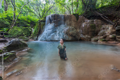 woman playing in the water and fishing around Small waterfall beside the road, Mae Sariang District, Mae Hong Son, Thailand