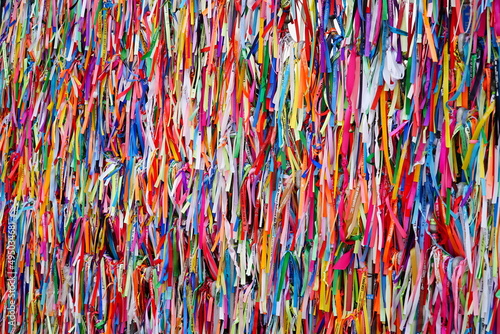 Religious ribbons with the inscription Remembrance of our Lady of Nazareth (Lembranca de Nossa Senhora de Nazaré). Believers attach them to fence of Cathedral of Our Lady of Grace in Belém, Brazil. photo