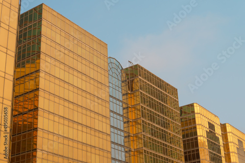 Exterior of glass mirror modern office buildings in sunny day blue sky background. Building and architecture concept.