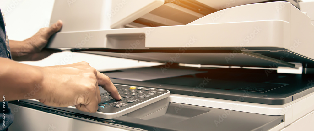 Copier printer, Close hand office man press copy button on to using the copier machine for scanning document printing a sheet paper and xerox photocopy. Stock-foto | Adobe