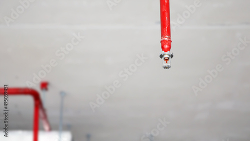Close-up fire sprinkler on the ceiling for fire detection and alarm system equipment in building safety security protect and prevent or prevention when heat or flame detector is alert.