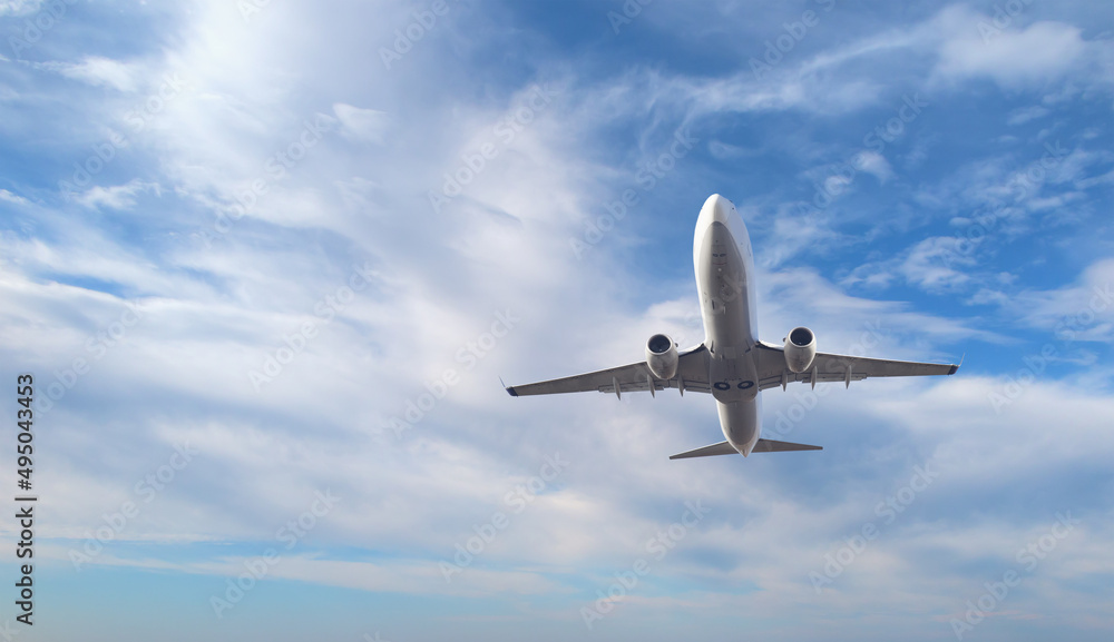 White passenger airplane flying in the sky amazing clouds in the background - Travel by air transport White passenger airplane flying in the sky amazing clouds in the background - Travel by air transport