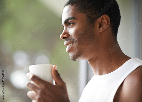Relaxing before my busy day. A handsome male holding a hot beverage.